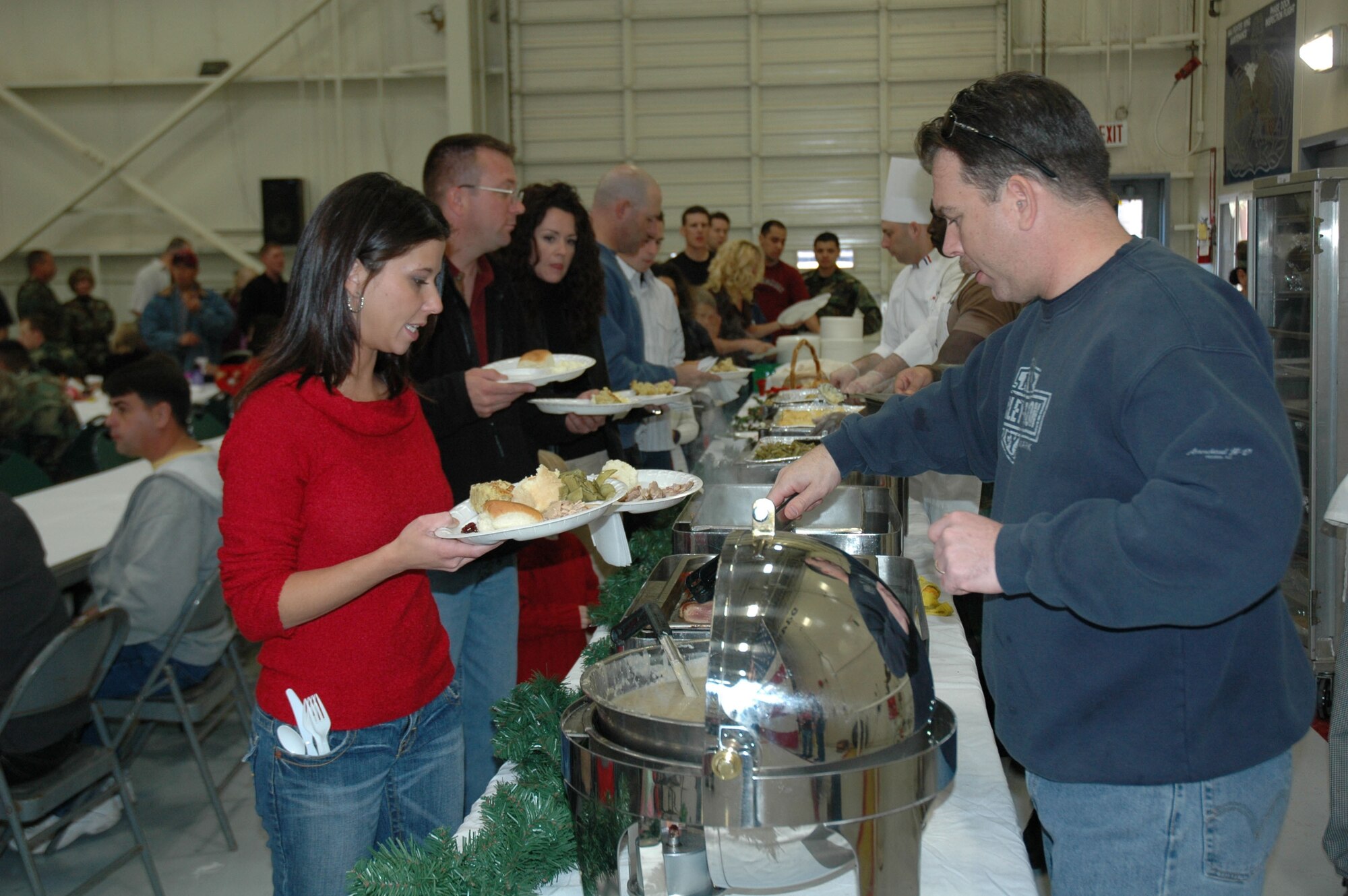 Senior Master Sgt. Dan Kelly, 944th Services Squadron, serves food during the 944th Fighter Wing's annual holiday picnic Dec. 3. Members of the 944th Services Squadron prepared the traditional holiday dinner in the base dining facility with the assistance of volunteers from the Art Institute of Phoenix Culinary Department. The volunteers were culinary students and the institute's master chef. (U.S. Air Force photo/Staff Sgt. Stephen Razo)