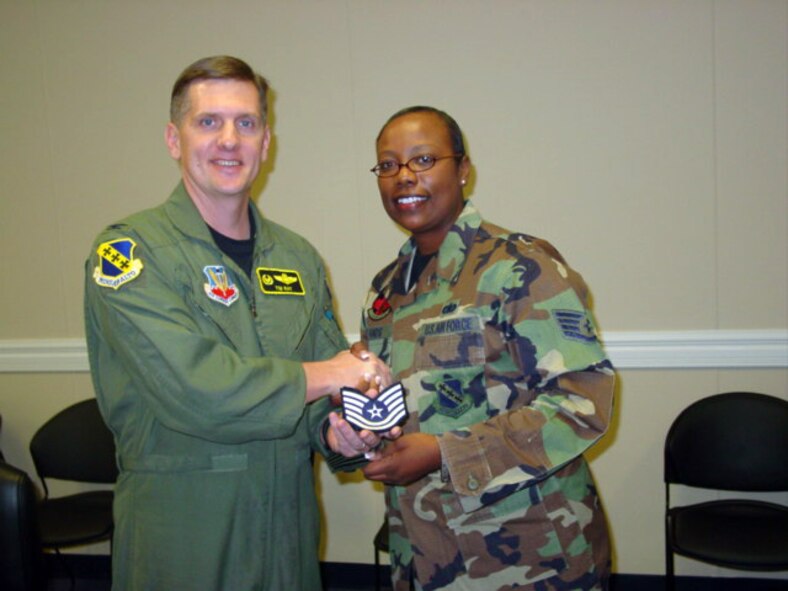 Staff Sgt. Yolanda Hands, 7th Operations Support Squadron noncommissioned officer in charge of client support administration, is promoted to technical sergeant by Col. Timothy Ray, 7th Bomb Wing commander, Dec. 12, through the Stripes To Exceptional Performers program.                           