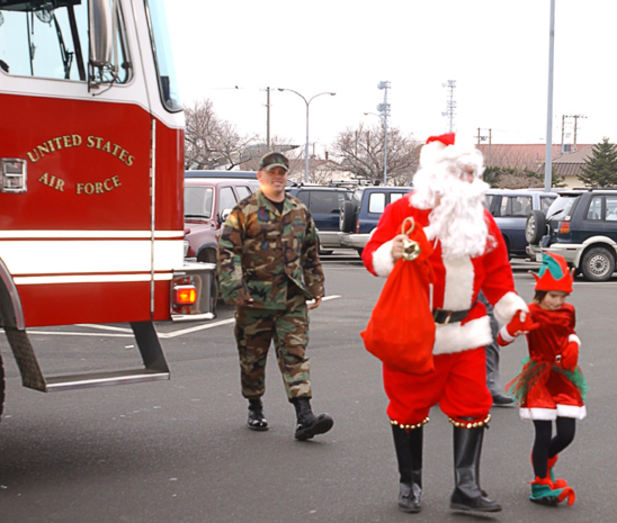 Misawa AB, Japan -- Santa Clause and his elf helper are escorted to the Commissary in style by the 35 Civil Engineering Squadron for the annual "Picture with Santa" at Misawa Air Base, Japan on December 23, 2006.  (U.S. Air Force photos by Senior Airman Laura R. McFarlane)