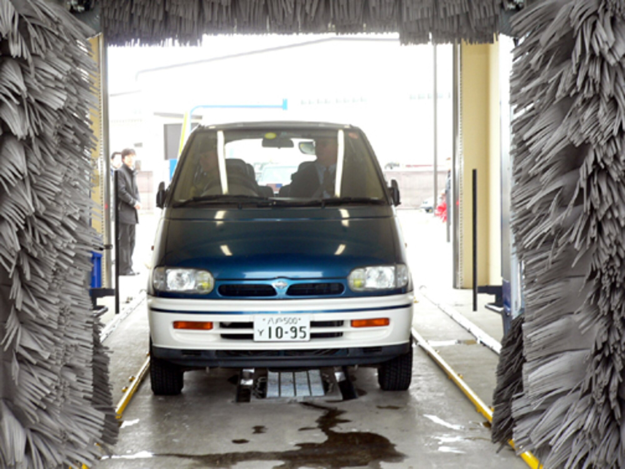 MISAWA AB, JAPAN -- Brig. Gen. Sam Angelella, 35th Fighter Wing and installation commander, takes his wife's  vehicle through the new car wash near the main base gas station after the ribbon cutting ceremony Dec. 29. The 24-hour yen coin-operated car wash has two stalls -- one is automated and the other is manual. The facility cost nearly $650,000 to build. The cost to wash a vehicle ranges from 100 for four minutes in the manual stall and 200 yen for the automated wash.