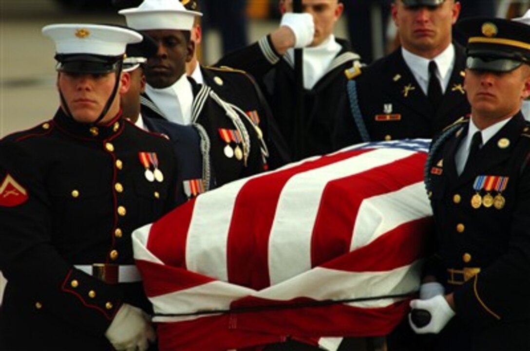 A multi-service honor guard guides the flag covered casket of former President Gerald R. Ford from Air Force One towards a waiting motorcade destined for his final resting place at the  museum named in his honor, the Gerald R. Ford Musuem, in Grand Rapids, Mich., Jan. 2, 2007.