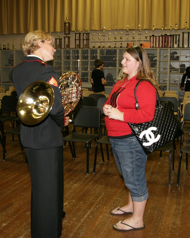 Parris Island Marine Band French hornist Sergeant Carrie Nell Westman speaks to a student after a performance at Dupont Manuel High School's Performing Arts School May 3.  A large percentage of the school's graduates go on to study music at major conservatories and universities across the country, and the Marines were excited and honored to perform for students of such acclaim.