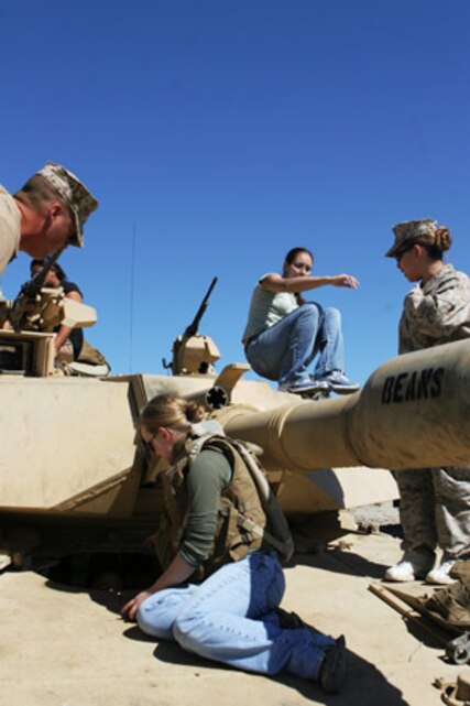 Jamie Guerrero gets a closer look at the M1A1 Abrams tank as other spouses check out the rest of the display at the Combat Center?s Range 500 during the 1st Tank Battalion Jane Wayne Day Oct. 4.