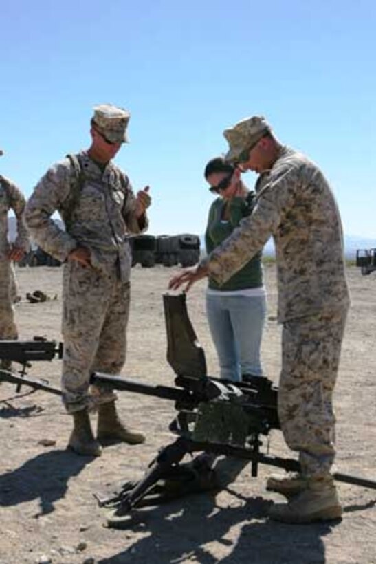 Marines from 1st Tank Battalion show Esther Macdonald how the MK19 40mm grenade launcher works at the Combat Center?s Range 500 during the 1st Tank Battalion Jane Wayne Day Oct. 4.