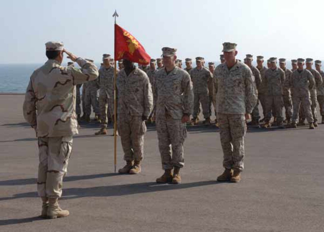 QUIQUE, Chile ? (June 4, 2007) Commanding officer of DIM Lynch, Chilean Marine Capt. (Col.) Humberto Mella, salutes Col. Brent Dunahoe, commanding officer of SPMAGTF 24, before speaking to a combined formation held to welcome all to a day of professional military education and exchanges here. Special Purpose Marine Air-Ground Task Force 24 is currently in Chile supporting Partnership of the Americas 2007, an annual exercise that enhances regional cooperation and security among nations of the Western Hemisphere.