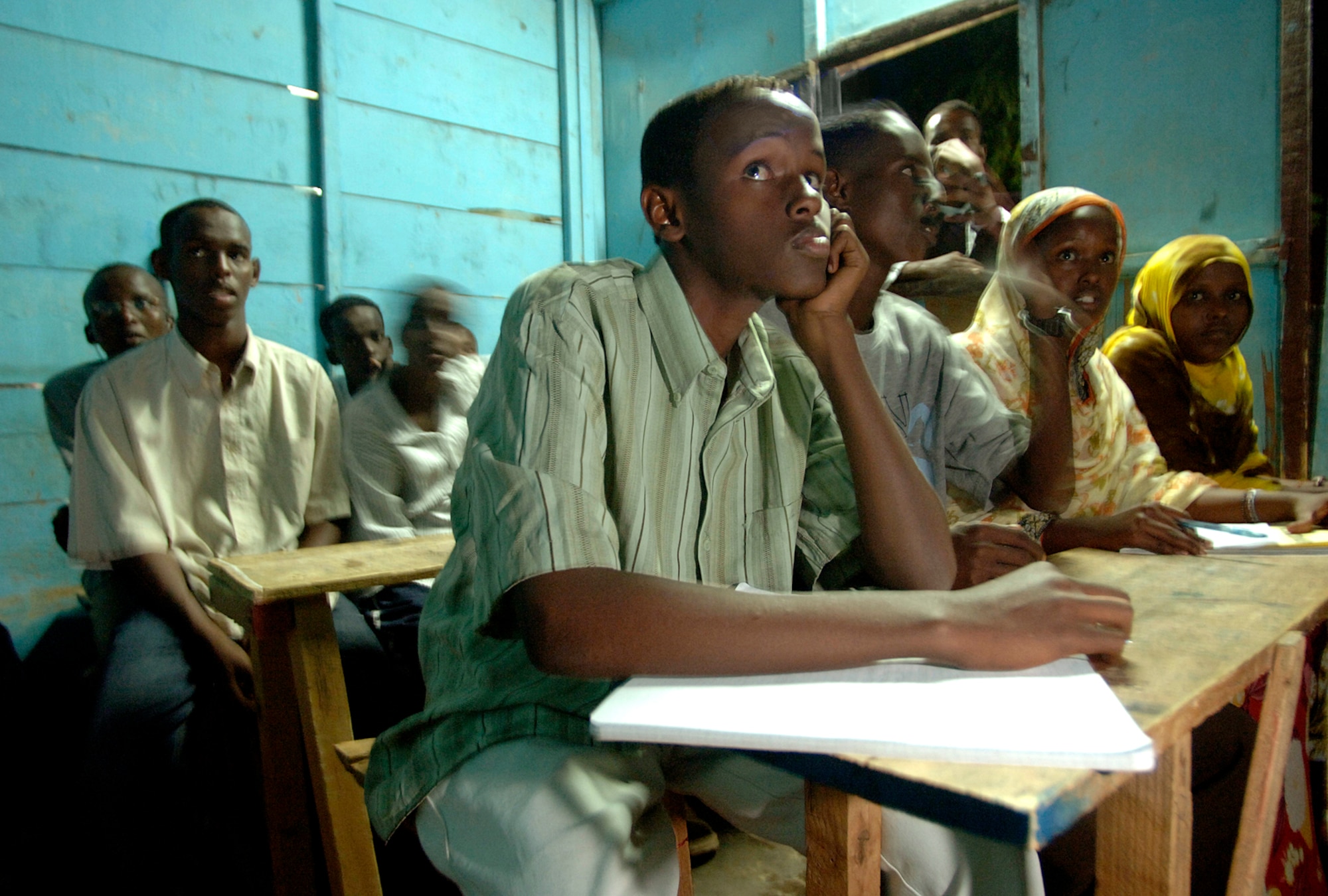 Djiboutian students at the Horsed Private School of English listen to a U.S. servicemember deployed to Camp Lemonier, Djibouti, answer a question about American culture and immigration. (U.S. Air Force photo/Master Sgt. Scott Wagers)
