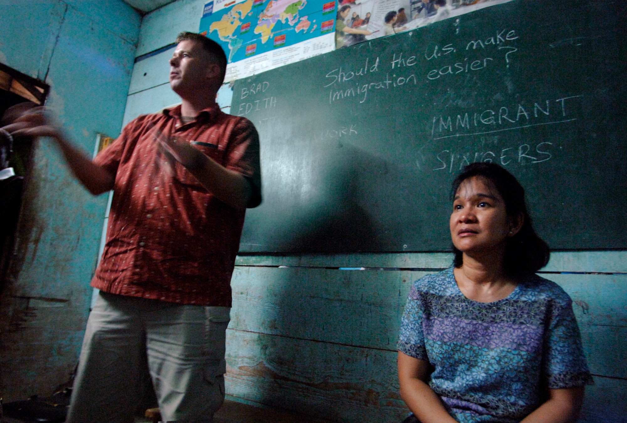Air Force Senior Master Sgt. Editha Garcia and Navy Petty Officer 1st Class Brad Hysell, who are deployed to Camp Lemonier, Djibouti, volunteer off-duty time to facilitate an English discussion forum with local students at the Horsed Private School of English. The students  are interested in learning about American culture and improving their English speaking skills. (U.S. Air Force photo/Master Sgt. Scott Wagers)
