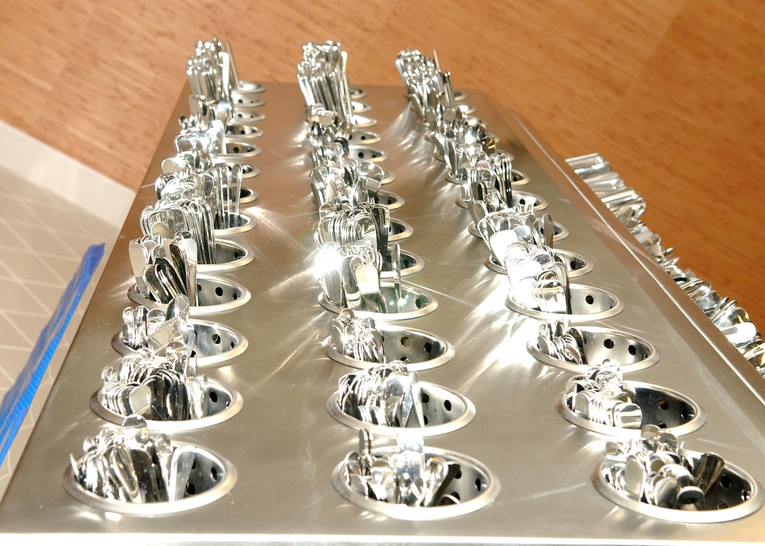Silverware glisten in their trays on opening day of the new dining facility on the Lackland Training Annex at Lackland Air Force Base, Texas. The dining facility mainly serves technical students and instructors from the 342nd, 343rd and 344th Training Squadrons, and members of the 90th Intelligence Squadron. The facility can hold up to 1,500 diners, has four serving lines and three dining areas, and has modern lighting and wooden floors. Construction of the dining facility, which replaced the 35-year-old Medina Inn, is among $60.3 million in major building projects scheduled for opening early this year.