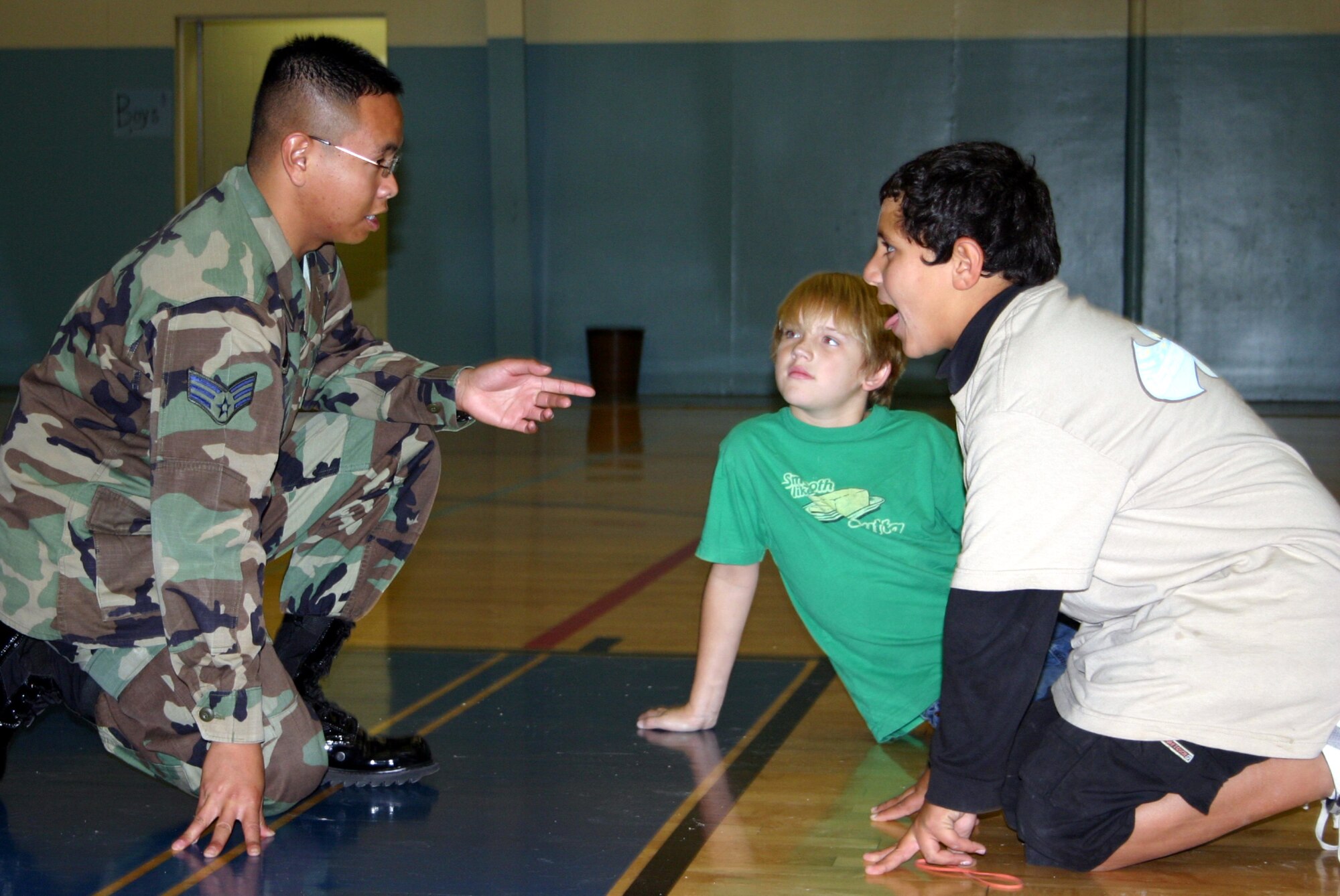 Senior Airman Boniface Sapno, 47th Security Forces Squadron, gives detailed instructions to a group of sixth-grade students during their annual Career Day.  The event, which involves months of planning, is aimed at making students aware of what career paths they might like to take during their secondary education and on. (U.S. Air Force photo by 2nd Lt. Courtney Kippenberger)