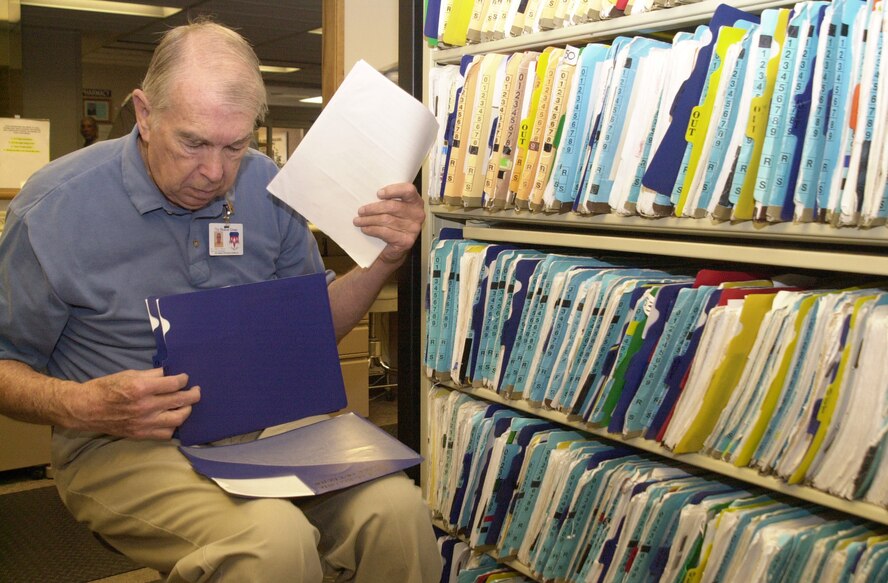 (Photo by Frank McIntyre) Marvin Laubach updates records for the 71st Medical Group. The 28 year Navy veteran, who retired as a commander in 1972 has been a volunteer at the clinic for eight years. A cookout saluting Mr. Laubach and other base volunteers will be held at the base picnic area from noon until 2 p.m. April 23.