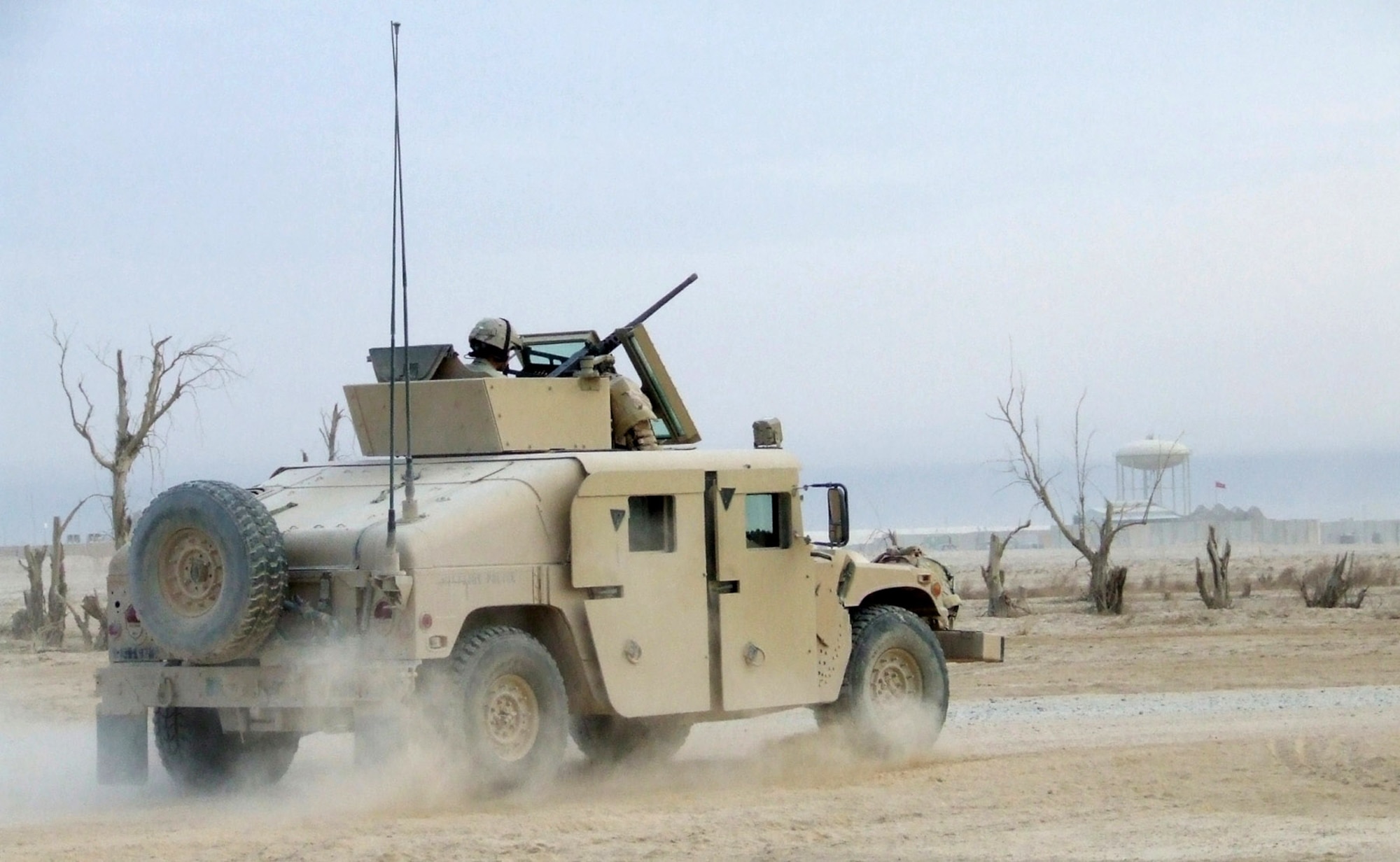 A humvee heads toward the gate of Contingency Operating Base Speicher, Iraq, manned by a team of Airmen from the 732nd Expeditionary Security Forces Squadron's Detachment 6. Detachment Airmen send convoys out daily to assess the capability of Iraqi police stations in the Salah ad Din province. (U.S. Air Force photo/Maj. Richard C. Sater)