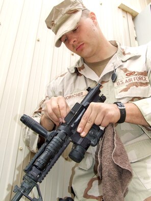 Senior Airman Ivan Morscher cleans his M-4 at Contingency Operating Base Speicher, Iraq. Airman Morscher is assigned to the 732nd Expeditionary Security Forces Squadron's Detachment 6 and is deployed from the 96th Security Forces Squadron at Eglin Air Force Base, Fla. (U.S. Air Force photo/Maj. Richard C. Sater) 
