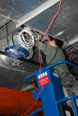 Steve Genailois, Horizon Metals located in Tyngsborough, Mass., works on the installation of the HVAC system in the ballroom. (US Air Force Photo by Jan Abate)