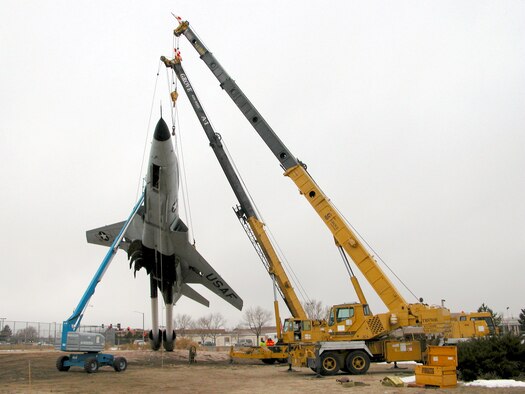 Workers attach crane lines to the McDonnell F-101B “VooDoo,” which was moved from the West Gate area Dec. 28 to make room for new outbound driving lanes. It took workers about four hours to move the 20,000 pound craft. The aircraft will be refurbished and reinstalled elsewhere after the West Gate project is done. The Army Corps of Engineers construction project is on time and estimated to be completed in January 2008.
Photo by Rick McKittrick/U.S. ACOE