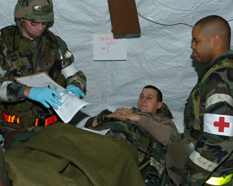 Maj. David Rogers and Staff Sgt. Pau Patterson, 4th Aeromedical Dental Squadron, treat an injured patient  during the operational readiness exercise Dec. 12. This simulation of self-aid and buddy care is one example of how it can help an Airman who is injured in combat. (U.S. Air Force photo by Airman 1st Class Greg Biondo) (released)