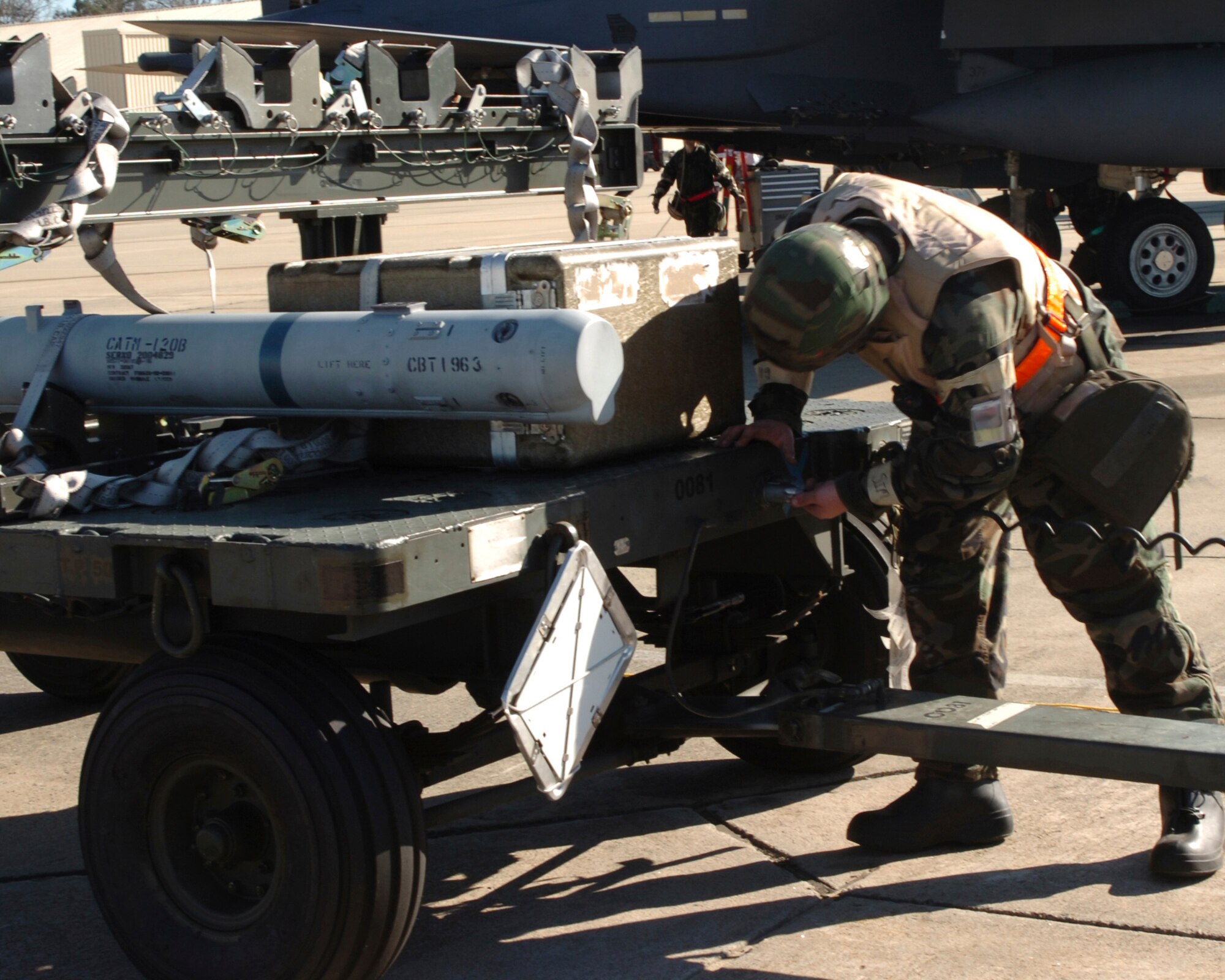 A 336th Weapons Airman unhooks a missile from a cart during the ORE December 12. The exercise is preparation for an operational readiness inspection January 23-26 that will evaluate the 4th Fighter Wing's ability to employ aircraft and resources, survive and operate, conduct mission support activities in a steady state combat environment, and to provide training opportunities to improve on existing capabilities. (US Air Force photo by Senior Airman Micky Bazaldua)(released) 