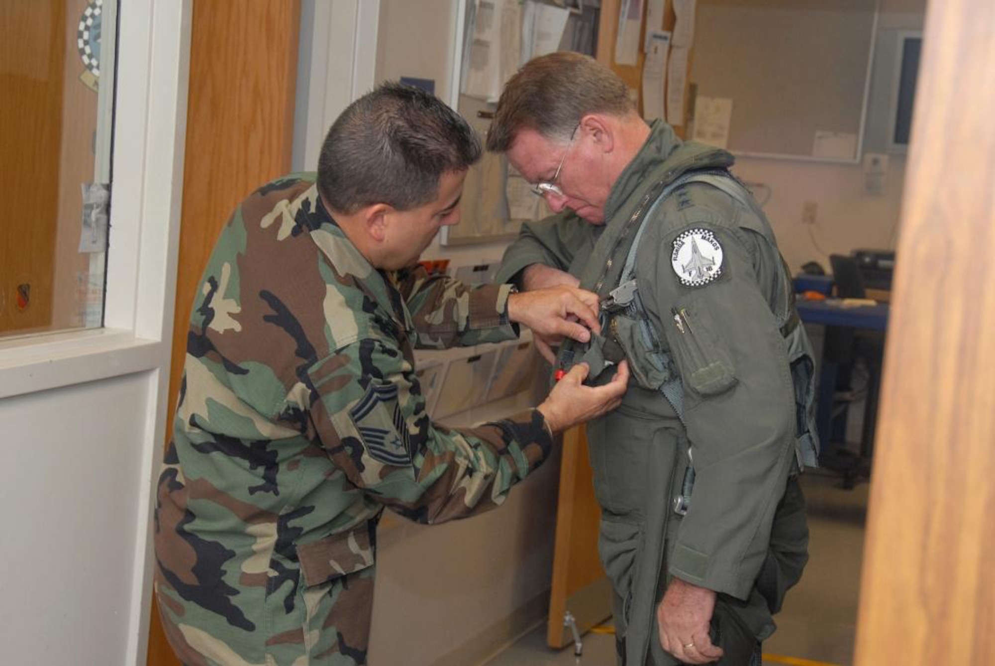 Senior Master Sgt. Antonio Romero, 93rd Fighter Squadron Life Support Chief, helps Lt. Gen. John A. Bradley, Commander of the Air Force Reserve Command and Chief of the Air Force Reserve, suit-up prior to flying with the 93rd FS Makos Dec. 13 here at Homestead Air Reserve Base, Fla. (U.S. Air Force photo/Master Sgt. Chance Babin) 