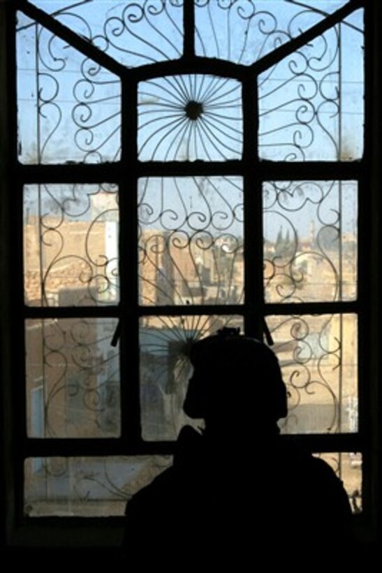 A U.S. Marine is silhouetted in a window as he searches a building during a patrol in Haqlaniyah, Iraq, on Dec. 21, 2006.  The Marine is attached to the 2nd Battalion, 3rd Marine Regiment, Regimental Combat Team 7, I Marine Expeditionary Force (Forward).  