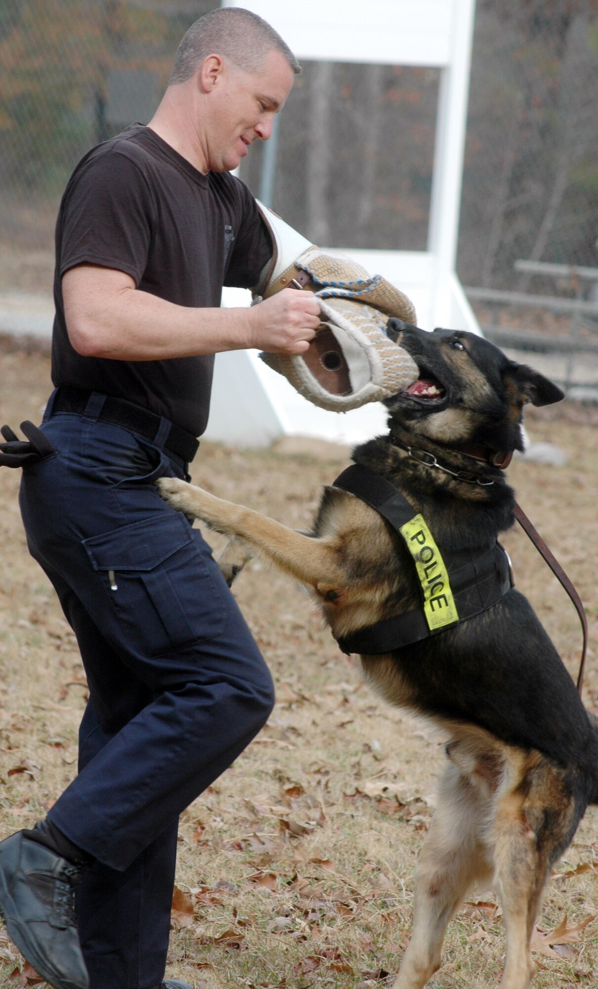 Officer Wayne Fisher, Warner Robins Police Department, fends off Ajax during a training exercise.  The local police trains their dogs with the Robins Air Force Base's military working dogs.  (U. S. Air Force photo by Sue Sapp)