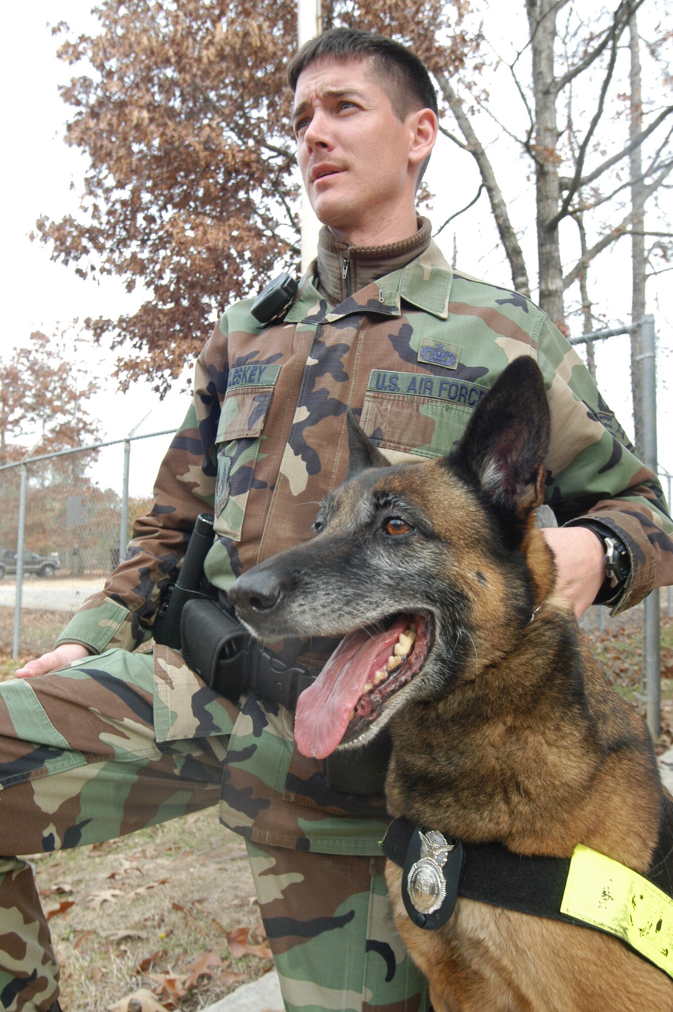 SSgt. Christopher McCleskey sits with Rudy, a military working dog who also wears the badge of the 78th Security Forces.   (U. S. Air Force photo by Sue Sapp)