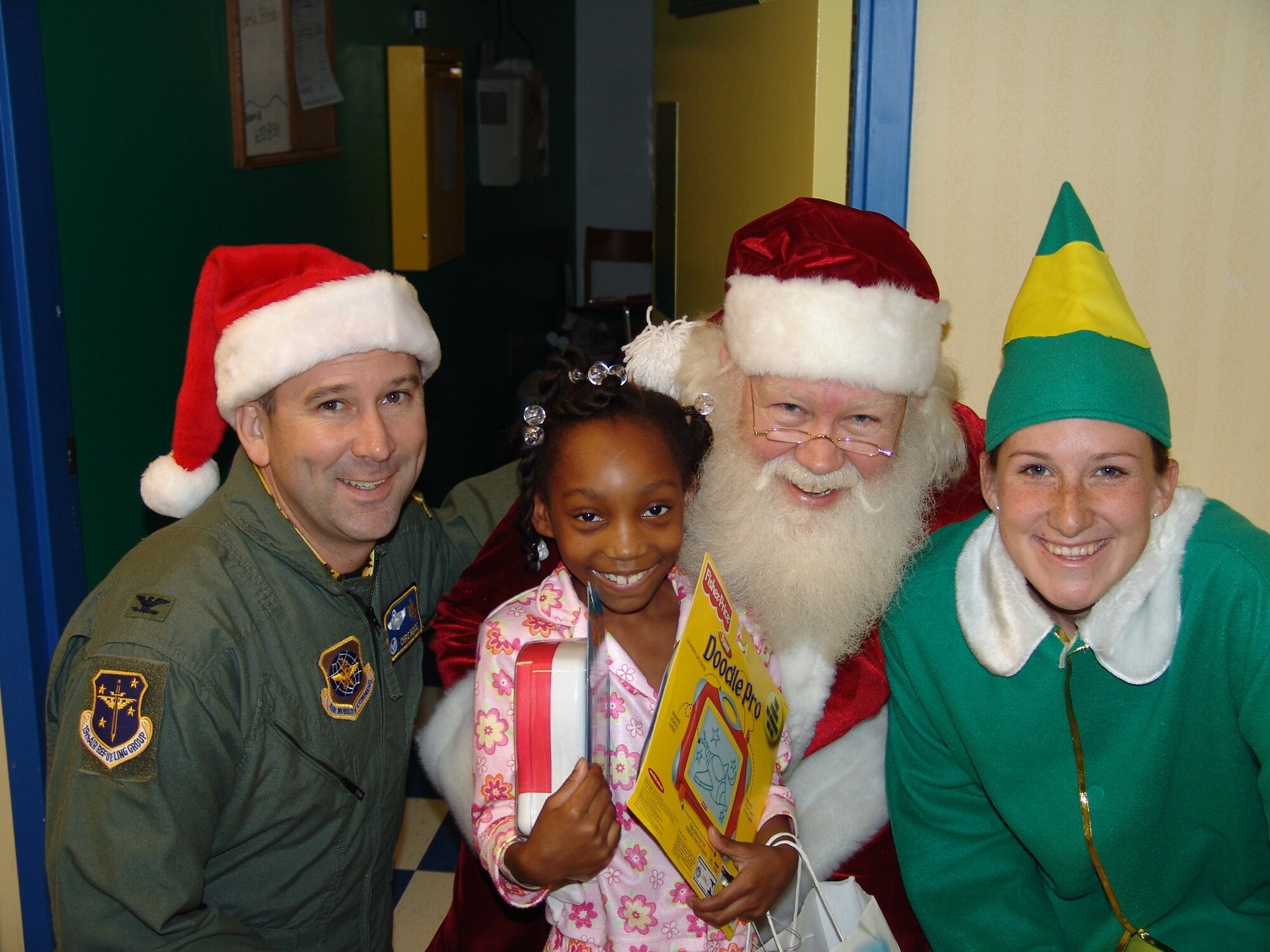 Col. Christopher J. Bence, commander, 19th Air Refueling Group, accompanies Santa on his trip to the Children's Hospital in Macon, Ga. The annual Toys for Team Robins program, headed by the 19th ARG, provided toys to children of Team Robins members, as well as 21 children at the hospital to help brighten the holiday season.