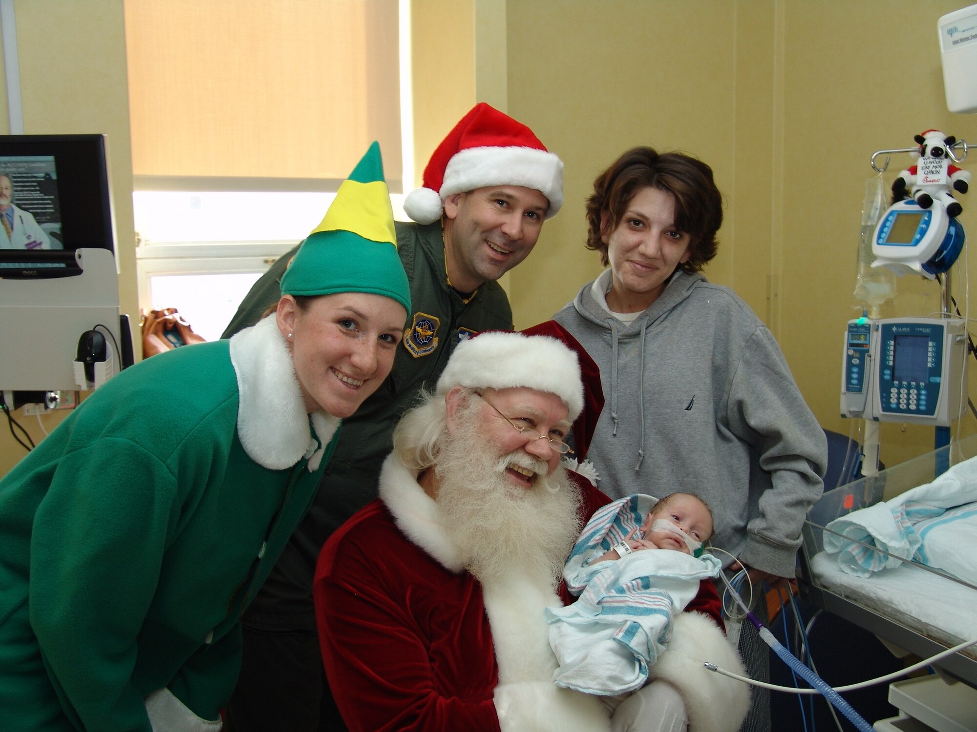 Col. Christopher J. Bence, commander, 19th Air Refueling Group, accompanies Santa on his trip to the Children's Hospital in Macon, Ga. The annual toys for Team Robins program, headed by the 19th ARG, provided toys children of Team Robins members, as well as 21 children at the hospital to help brighten the holiday season.