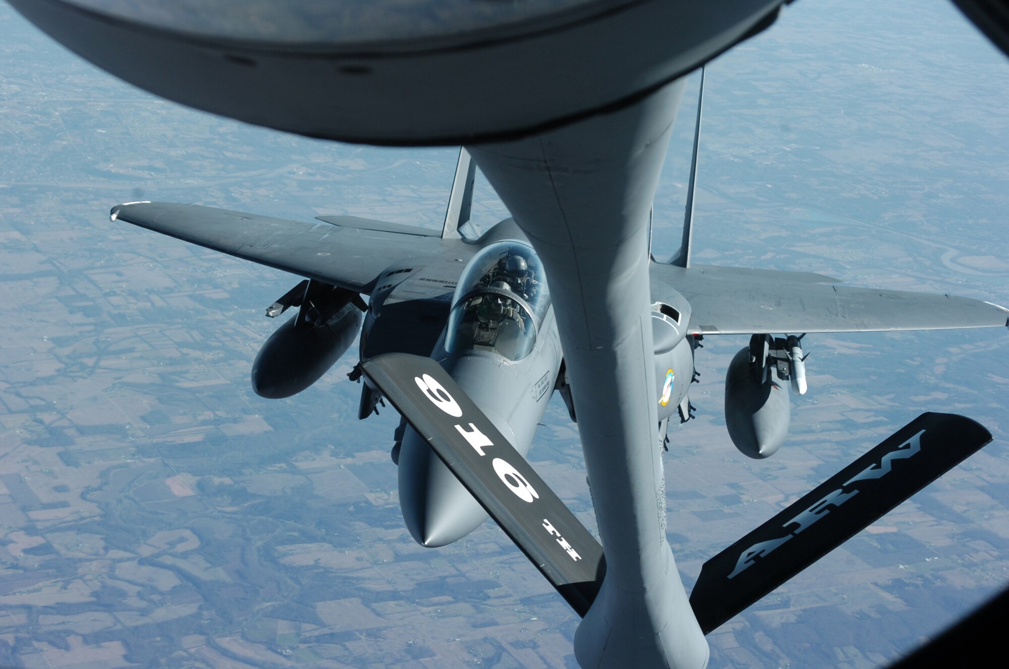 Members of the 916th Air Refueling Wing, Air Force Reserve, refuel their 4th Fighter Wing counterparts over Michigan skies on Wednesday afternoon as part of President Gerald Ford's funeral. Twenty-one F-15 Fighting Falcons and three KC-135 Stratotankers based at Seymour Johnson Air Force Base, N.C. took part in the final ceremonies to honor a veteran and their former commander-in-chief. (U.S. Air Force photo by A1C Greg Biondo)(released)