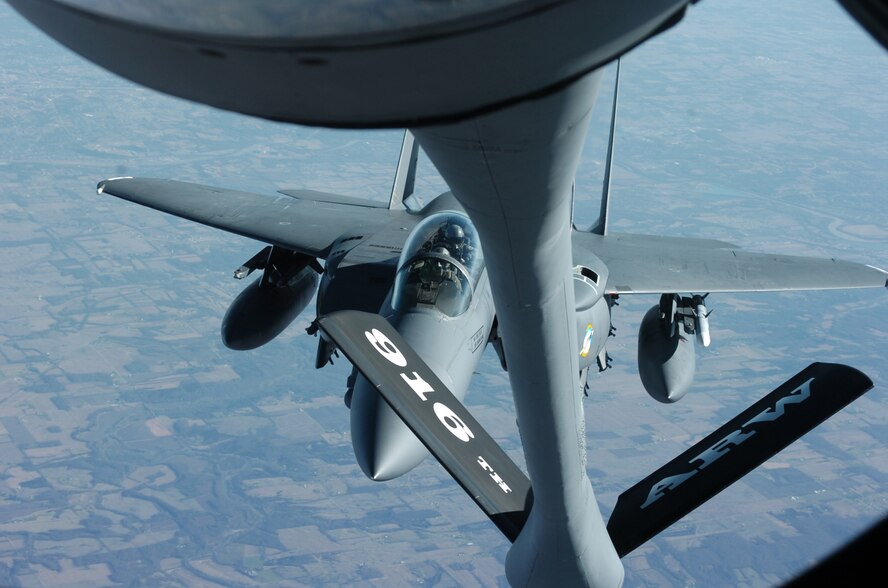 Members of the 916th Air Refueling Wing, Air Force Reserve, refuel their 4th Fighter Wing counterparts over Michigan skies on Wednesday afternoon as part of President Gerald Ford's funeral. Twenty-one F-15 Fighting Falcons and three KC-135 Stratotankers based at Seymour Johnson Air Force Base, N.C. took part in the final ceremonies to honor a veteran and their former commander-in-chief. (U.S. Air Force photo by A1C Greg Biondo)(released)