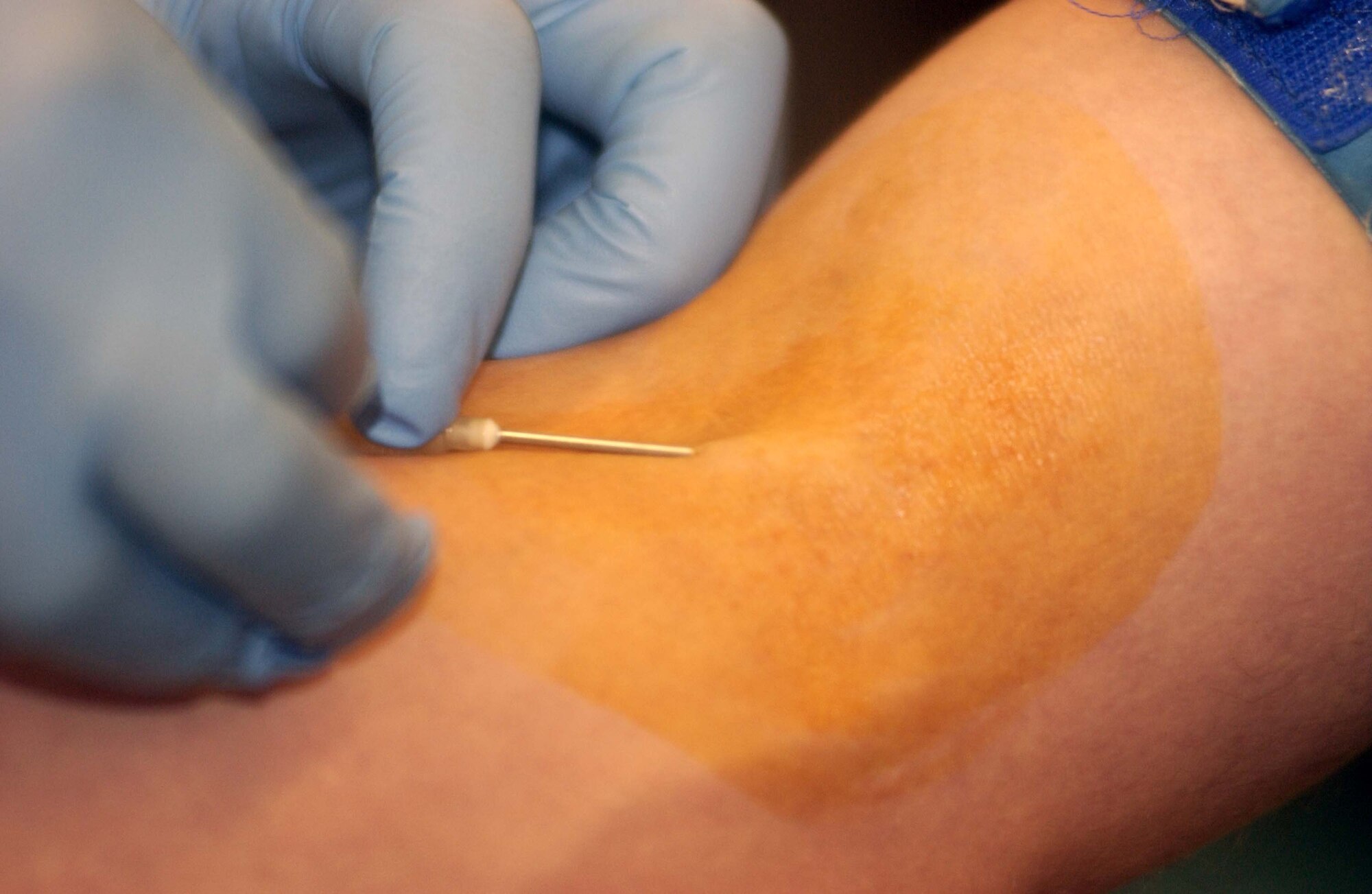 Petty Officer 2nd Class Brian King, from the U.S. Army Europe Blood Donor Center, inserts the needle during the 723rd Air Mobility Squadron's blood drive Dec. 13 at the 64th Replacement Battalion in the Ramstein Passenger Terminal. 
