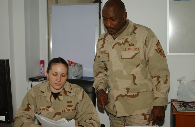 BALAD AIR BASE, Iraq -- 1st Lt. Jamie Fanning 332nd Expeditionary Mission Support Group PERSCO team chief and Senior Master Sgt. Tony Pinkney PERSCO superintendent goes over paperwork Jan. 2. Lieutenant Fanning and Sergeant Pinkney are deployed from Andrews Air Force Base, Md. (U.S. Air Force photo by Staff Sgt. Alice Moore)