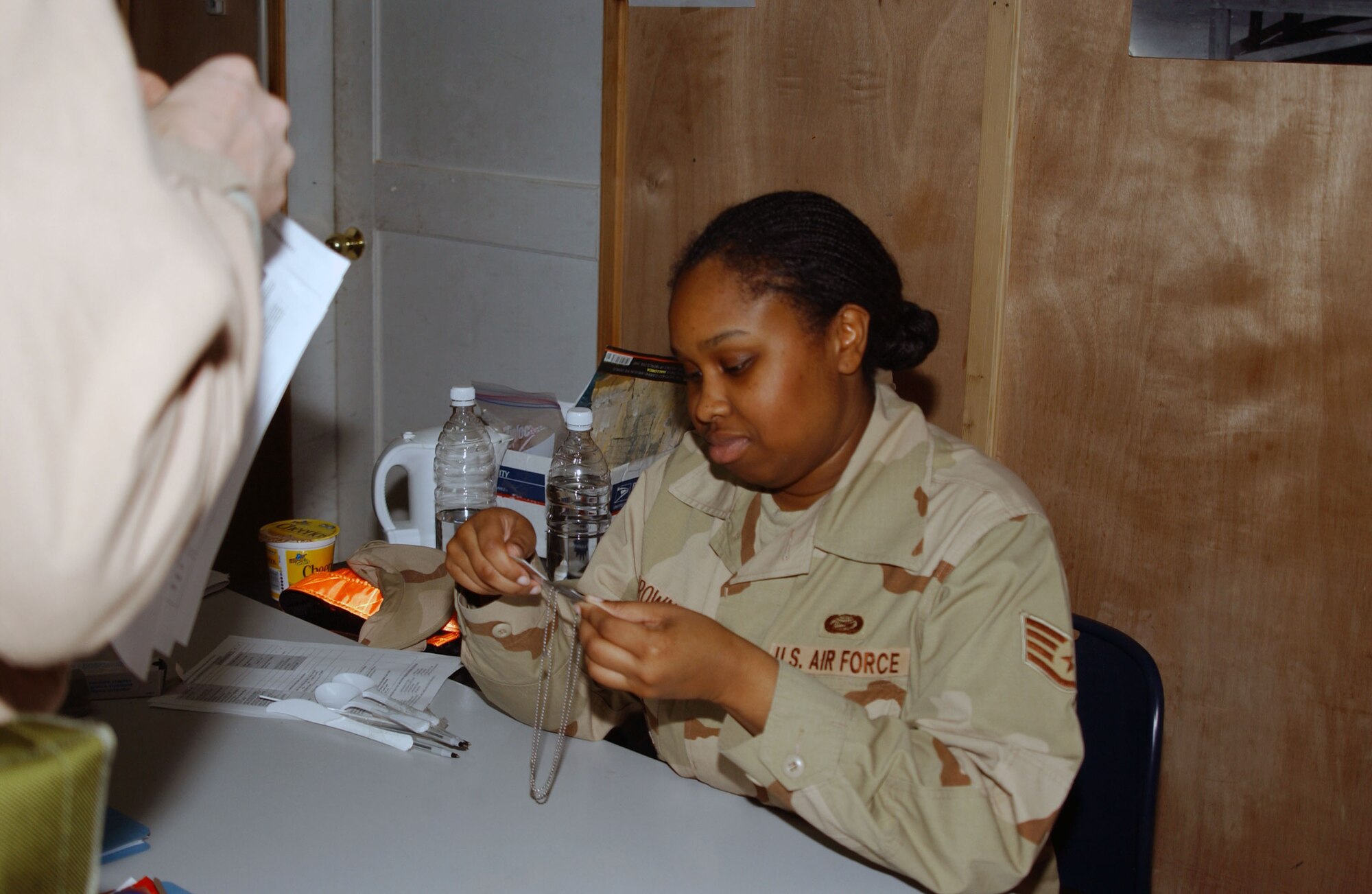BALAD AIR BASE, Iraq -- Staff Sgt. Shereka Brown 332nd Expeditionary Mission Support Group PERSCO team member, verifies identification information Jan. 2. Sergeant Brown is deployed from Andrews Air Force Base, Md. (U.S. Air Force photo by Staff Sgt. Alice Moore)