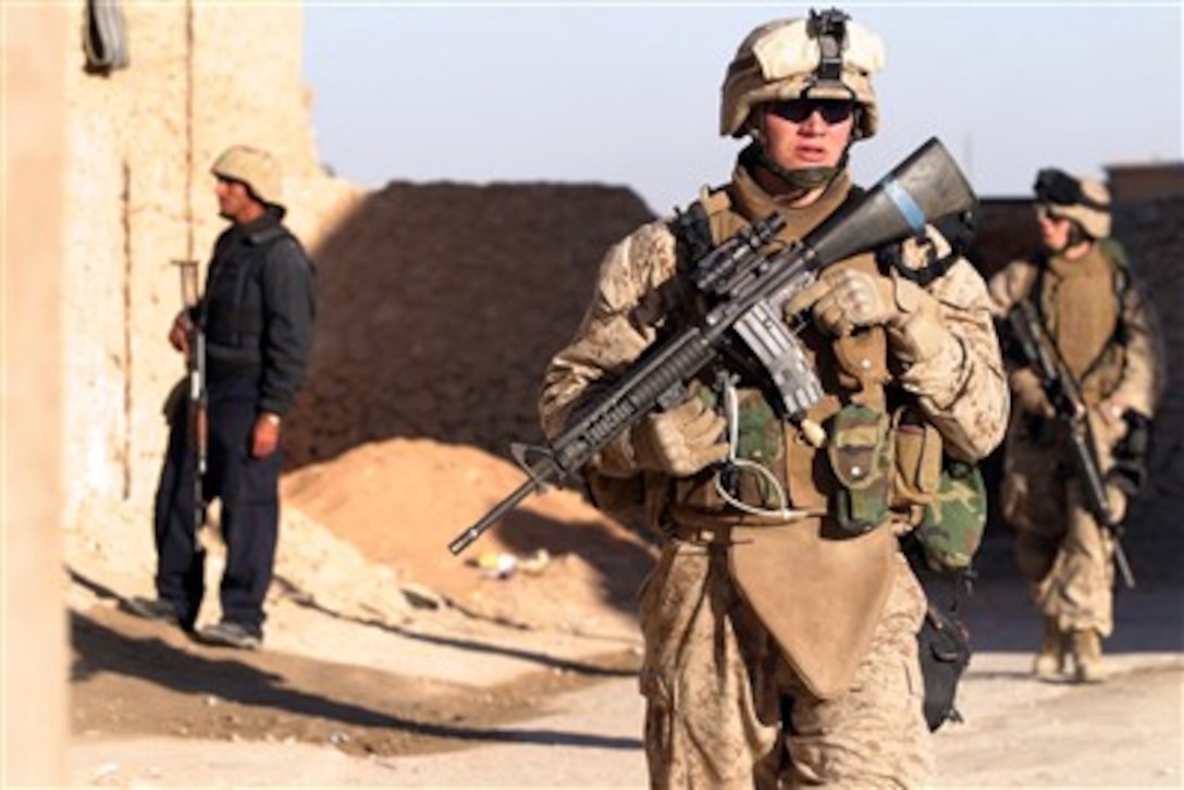 U.S. Marines with 2nd Battalion, 3rd Marine Regiment, Regimental Combat Team 7, I Marine Expeditionary Force (Forward) and an Iraqi police officer conduct a patrol in Haqlaniyah, Iraq, on Dec. 20, 2006.  