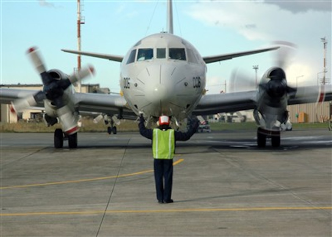 U.S. Navy Petty Officer 3rd Class Jenny Dimanche signals to the crew of a P-3C Orion, from Patrol Squadron 5, that the number three propeller is turning at Sigonella, Sicily, Jan. 3, 2007.