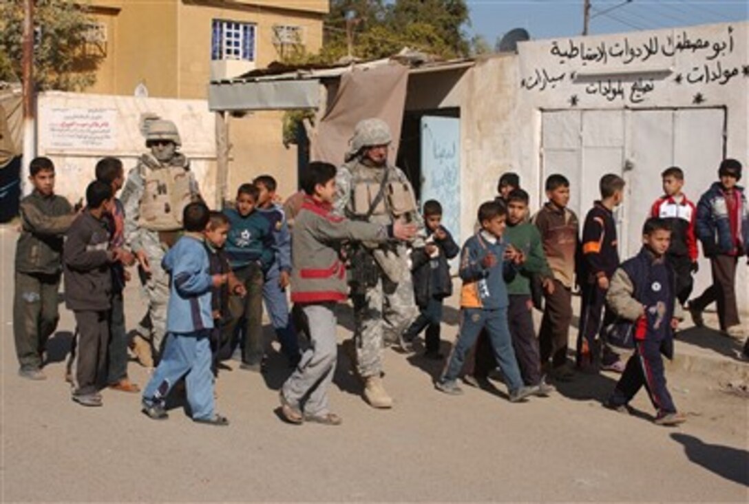 Iraqi children greet U.S. Army soldiers from the 1st Battalion, 37th Field Artillery Regiment, 3rd Brigade Combat Team, 2nd Infantry Division, in Al Rashidiyah, Iraq, Jan. 2, 2007.