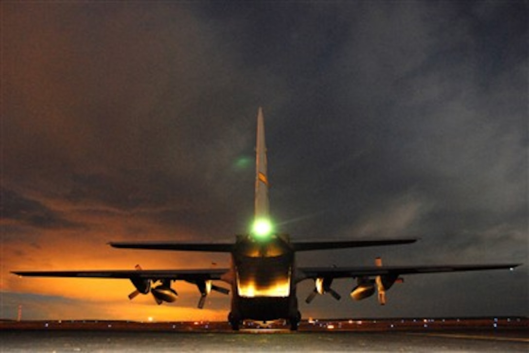 A Wyoming Air National Guard C-130 Hercules aircraft prepares to depart from Pueblo Memorial Airport, Colo., on Jan. 3, 2006, after being loaded with hay bales.  The hay will be dropped in southeast Colorado to help feed livestock stranded by a snow storm.  