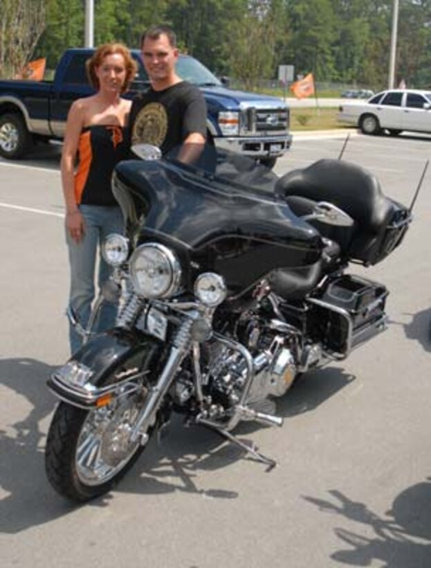 Staff Sgt. Nicholas Chaplin, an explosive ordnance disposal technician and Purple Heart recipient with Marine Corps Base EOD and his wife Melisa Chaplin stand next to his remodeled 2007 Harley-Davidson. The crew from the television show ?American Thunder,? a motorcycle-enthusiast program that airs on Speed TV, restored Chaplin motorcycle to "service members who are out fighting for our freedom," said Jay Barbieri, project manager for American Thunder.