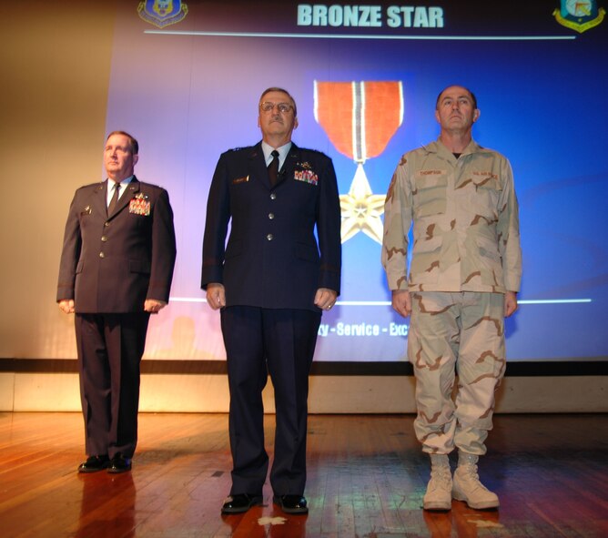 Maj. Gen. Martin M. Mazick, 22nd Air Force commander, presents a bronze star to Chief Master Sgt. Kenneth Thompson, 512th Equipment Maintenance Squadron first sergeant, during the 512th Airlift Wing commander's call in December. Chief Thompson earned the medal for his one-year tour in Iraq.  He is a member of the 512th AW, an Air Force Reserve Command unit.