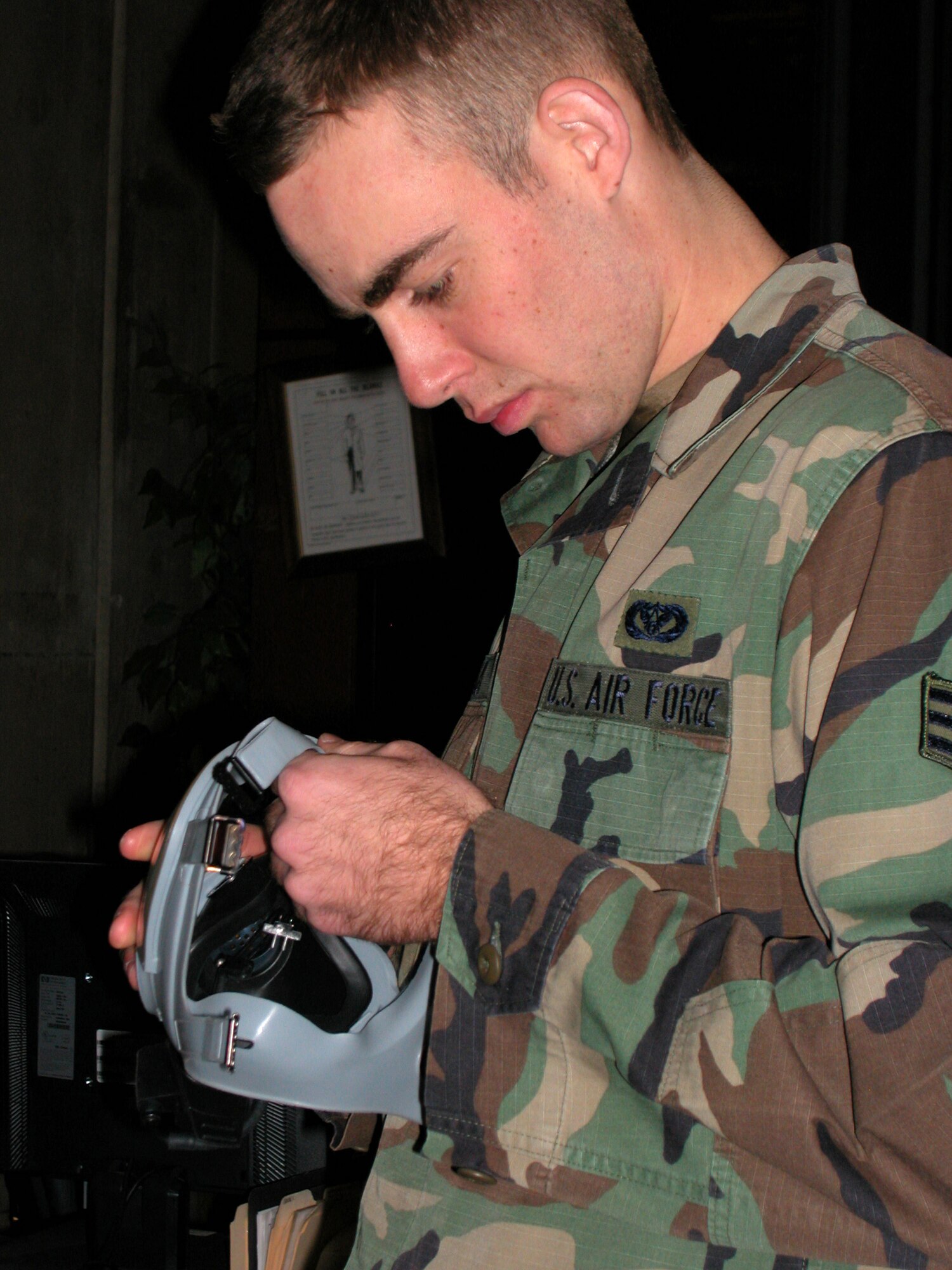 Air Force Reservist Senior Airman Grant Kohler with the 940th Civil Engineering Squadron, inspects his mask after being issued his deployment equipment Jan. 6, at Recce Town, Beale Air Force Base, Calif.  Airman Kohler, a structural specialist, will be deploying to South West Asia in support of Operation Enduring Freedom; this will mark his first deployment to the region. (U.S. Air Force photo/Tech. Sgt. Brynna Bryant)