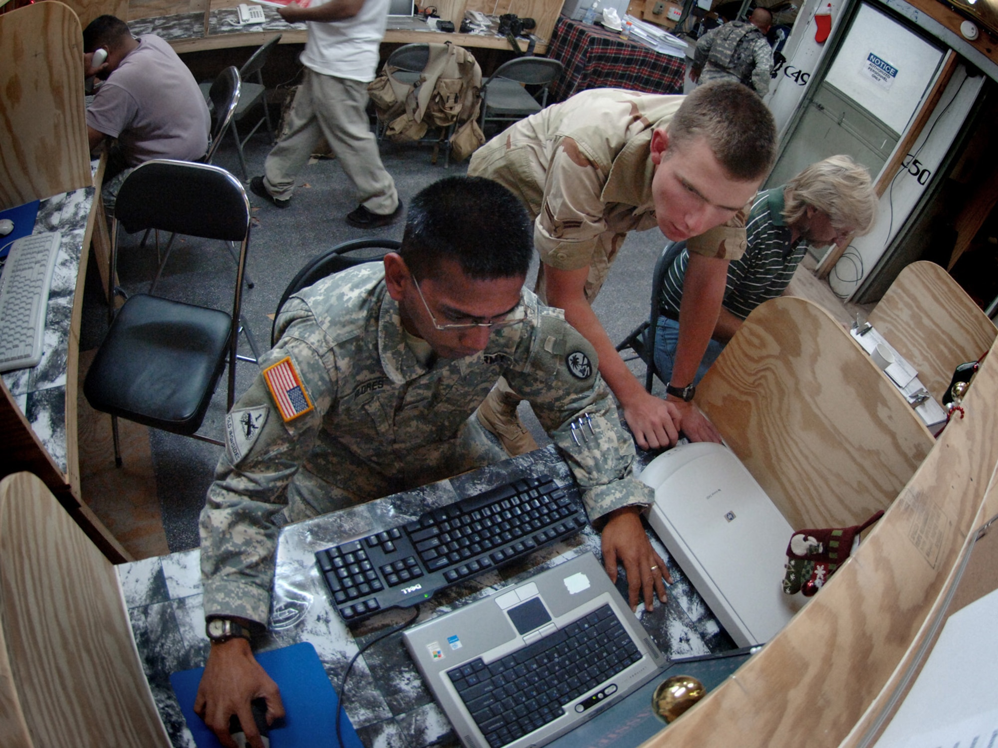 Airman 1st Class Steven Brumley, standing, troubleshoots a network connectivity problem with Guam Army National Guardsman Sergeant Patrick Flores. Both are deployed to Deployed to Contingency Operating Location Bilate, Ethiopia. (U.S. Air Force photo/Master Sgt. Scott Wagers)

