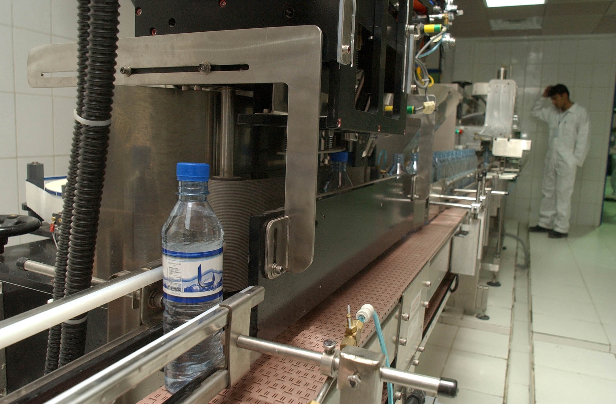 Bottles of Aria water pass through the production line here Jan. 7. When operating at full capacity, the plant?s four production lines will produce 400,000 bottles of water per day. (U.S. Army photo/Sgt. Michael J. Taylor)