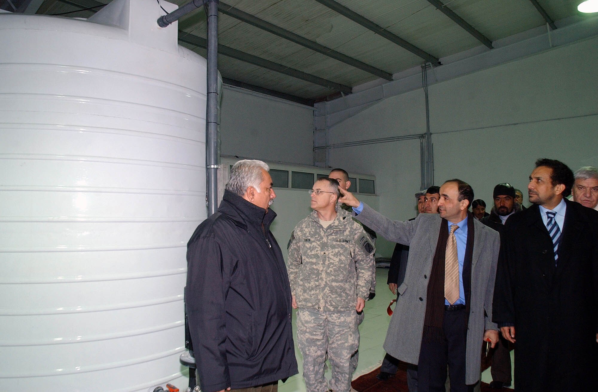 Aria Water Bottle plant owner John Ramin escorts a group of visitors including Afghan Vice President Ahmad Zia Massoud around the new plant as he gives them a tour Jan. 7. (U.S. Army photo/ Sgt. Michael J. Taylor)