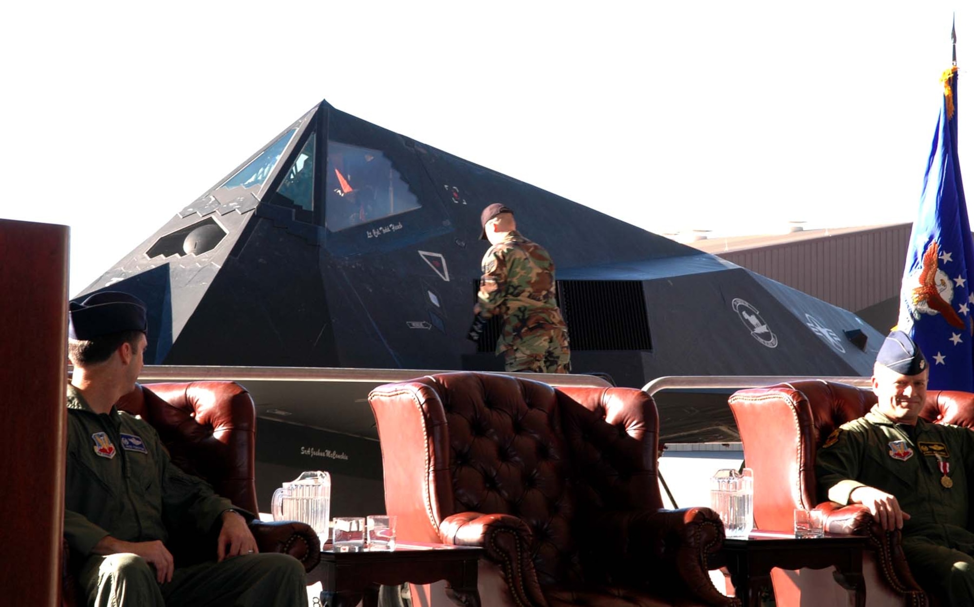 Col. Jack Forsythe, 49th Operations Group commander, looks on as Lt. Col. Todd Flesch's name is revealed on an F-117A as he takes command of the 8th Fighter Squadron. (U.S. photo taken by Airman Jamal Sutter)
