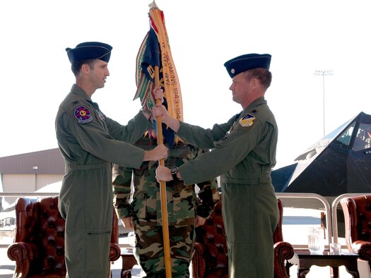 Col. Jack Forsythe, 49th Operations Group commander, hands the 8th Fighter Squadron guidon to Lt. Col. Christopher Williams, new 8 FS commander, signifying the change of command in a ceremony Jan. 5. (U.S. photo taken by Airman Jamal Sutter)