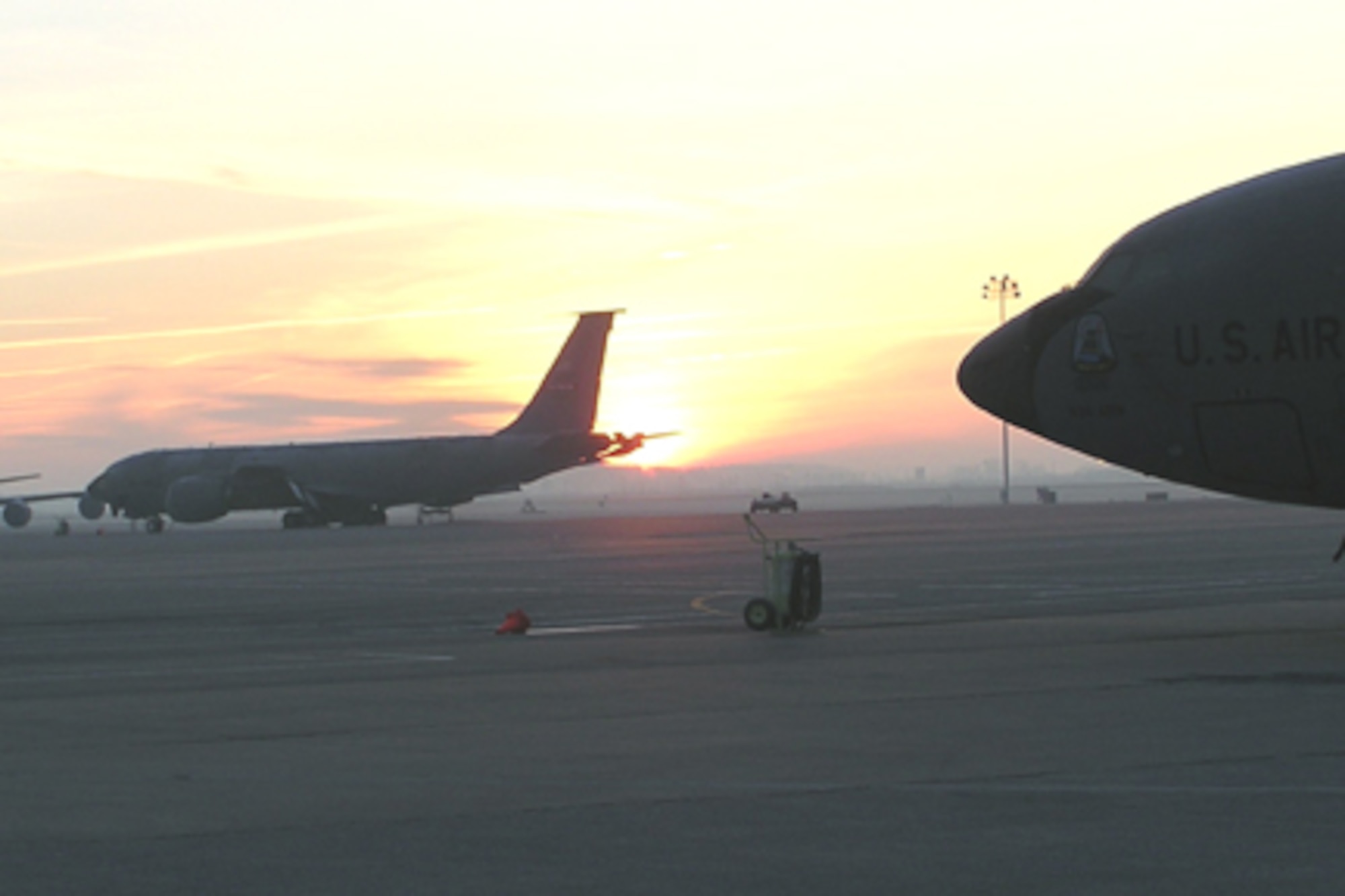 GRISSOM AIR RESERVE BASE, Ind -- The sun begins to rise over KC-135 Stratotankers parked on the flightline at Grissom ARB.  Grissom is home to the 434th Air Refueling Wing, the largest KC-135 wing in the Air Force Reserve Command.  The 434th ARW also plays an import role in the local economy with an annual economic impact of more than $86 million.   (U.S. Air Force photo/Mr. MIke Woloshuk) 