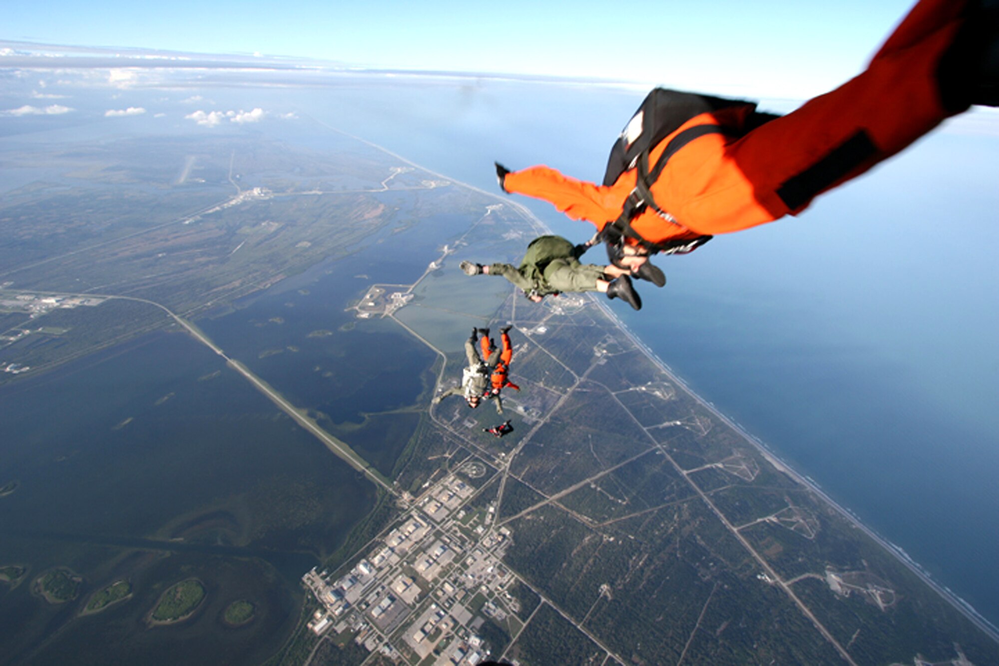 American and Canadian pararescue jumpers launch into the air as part of an international search and rescue exercise Jan. 5 over Cape Canaveral Air Station, Fla. Air Force Reserve Command PJs from the 920th Rescue Wing at Patrick Air Force Base, Fla., participated with Canadian rescue forces from the 435th Air Transport and Rescue Squadron based in Winnipeg, Manitoba. "Working with the Canadians has given us the opportunity to exchange invaluable procedures and techniques for rescue training and implementation," said Lt. Col. Dan Byers, the exercise coordinator and an HC-130 pilot with the 39th Rescue Squadron at Patrick AFB. (U.S. Air Force photo/Tech. Sgt. Robert Grande)
