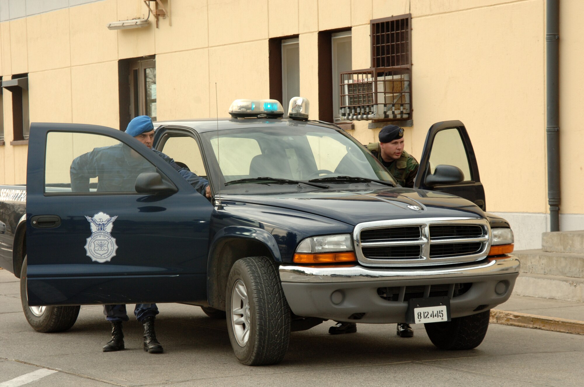 Staff Sgt. Shawn Benjamin, 39th Security Forces Squadron patrolman TDY here from Peterson Air Force Base, Co. and Ahmat iNCi, Turkish Air Force specialist sergeant, prepare to do a vehicle stop here Jan. 4. (U.S. Air Force photo by Airman 1st Class Kelly Leguillon)