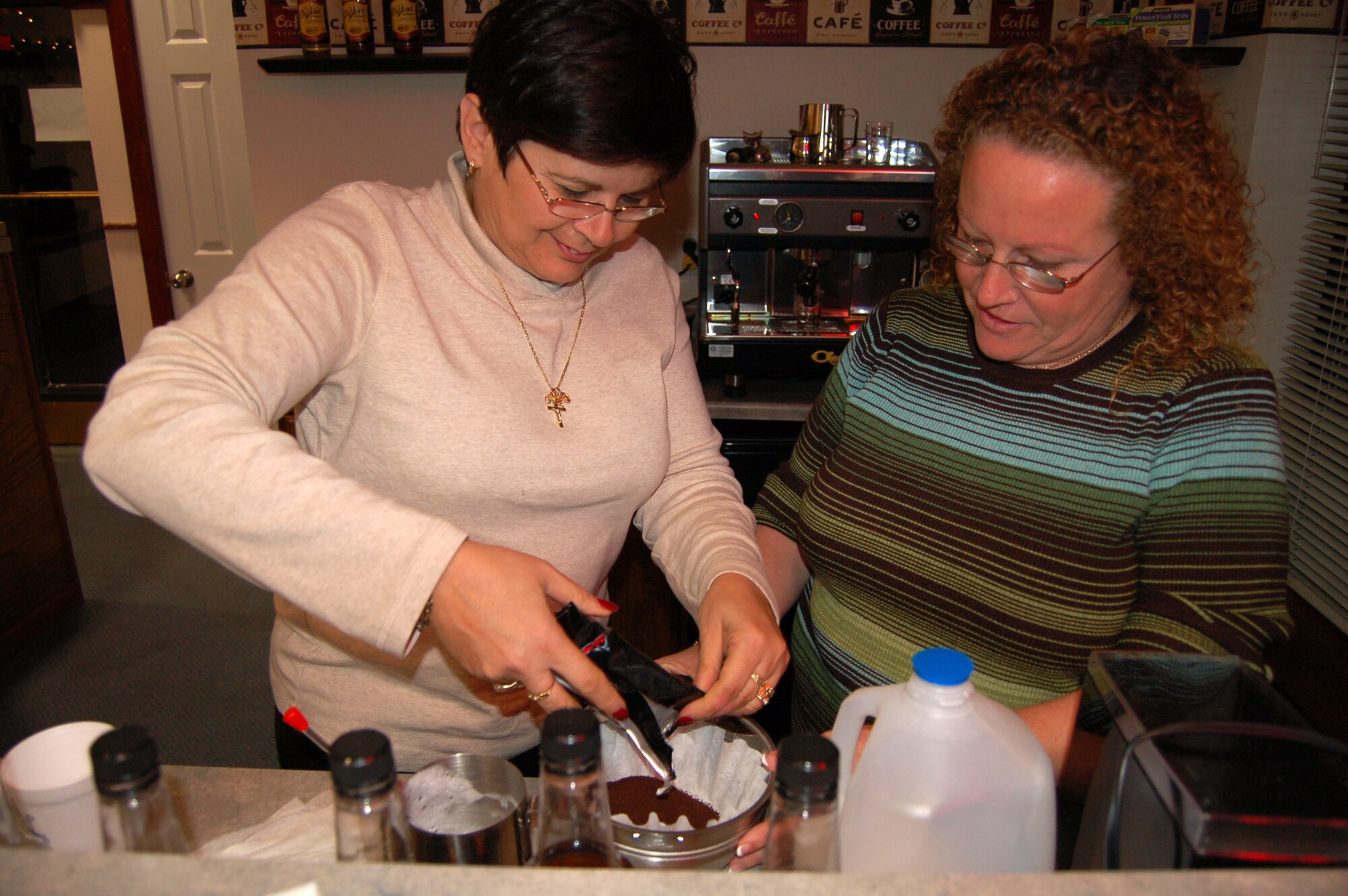 Donna Roosa (left) and Debbie Suto, Eagle's Net Coffee House volunteers, make coffee for Airmen visiting the coffee house Jan. 3. The coffee house is located in Dorm 435 and is open to all Airmen E-4 and below. 