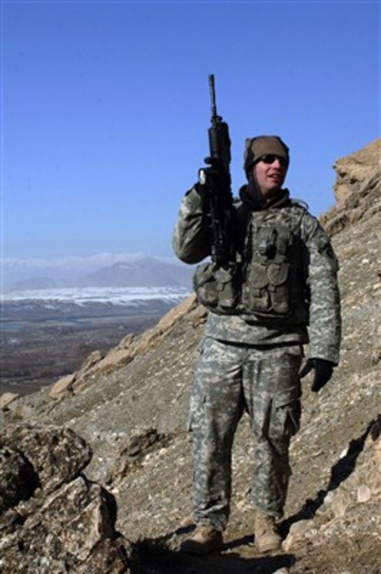 U.S. Army Sgt. Andrew Knauf climbs a mountain to search for possible enemy observation posts and weapons caches near Dingak, Afghanistan, on Jan. 3, 2007.  Knauf is attached to Bravo Company, 1st Battalion, 102nd Infantry Regiment.  