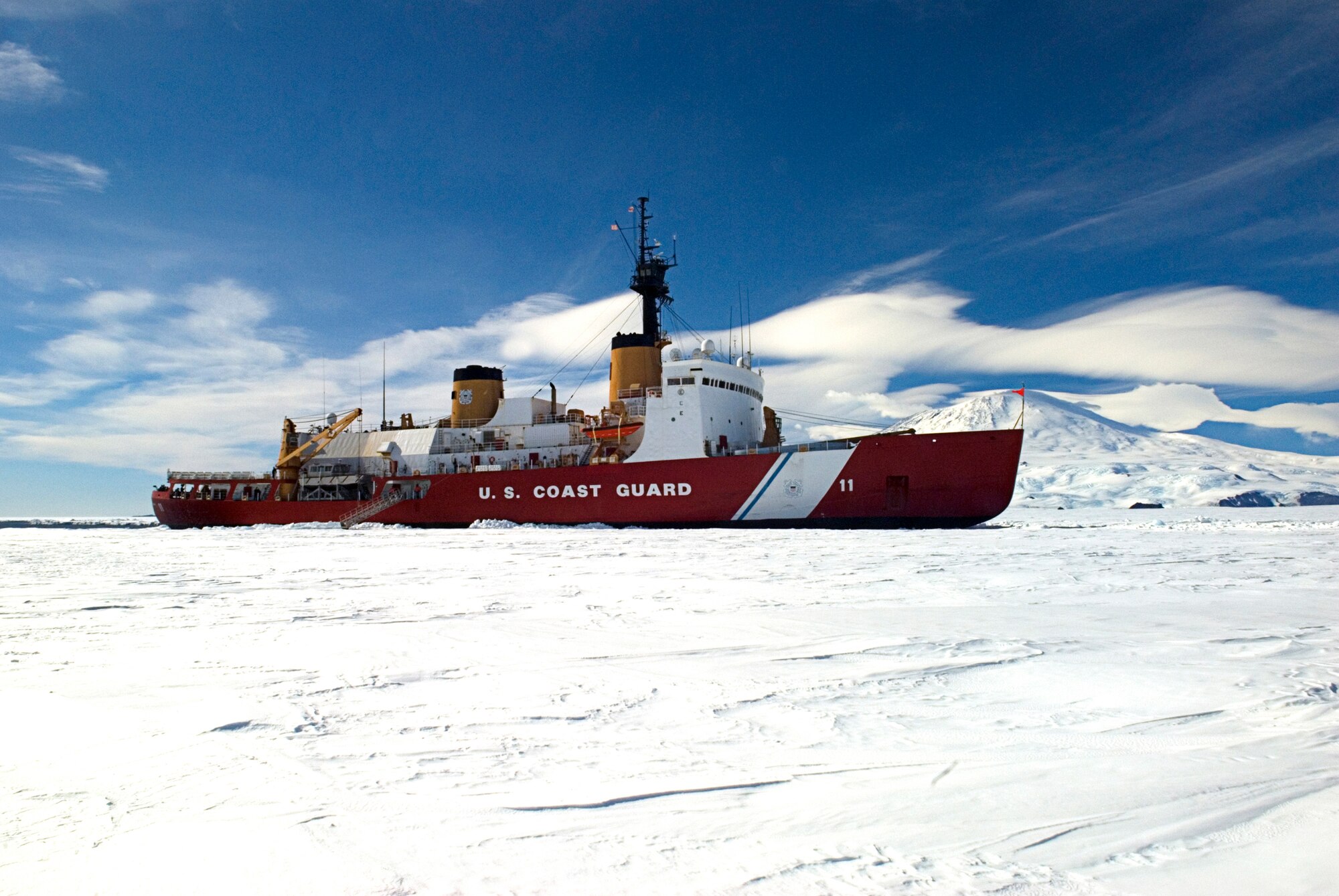 ANTARCTICA - The Coast Guard Cutter Polar Sea pauses from its ice-breaking duties in front of Mt. Erebus, while members of the National Science Foundation came aboard to meet with senior officers.  The Polar Sea is in Antarctica as part of the Air Force-led Joint Task Force Support Forces Antarctica, Operation Deep Freeze 2007, clearing a navigable channel for supply ships to get needed equipment and goods to scientists working in McMurdo. U. S. Coast Guard photo by Petty Officer 3rd Class Kevin Neff.