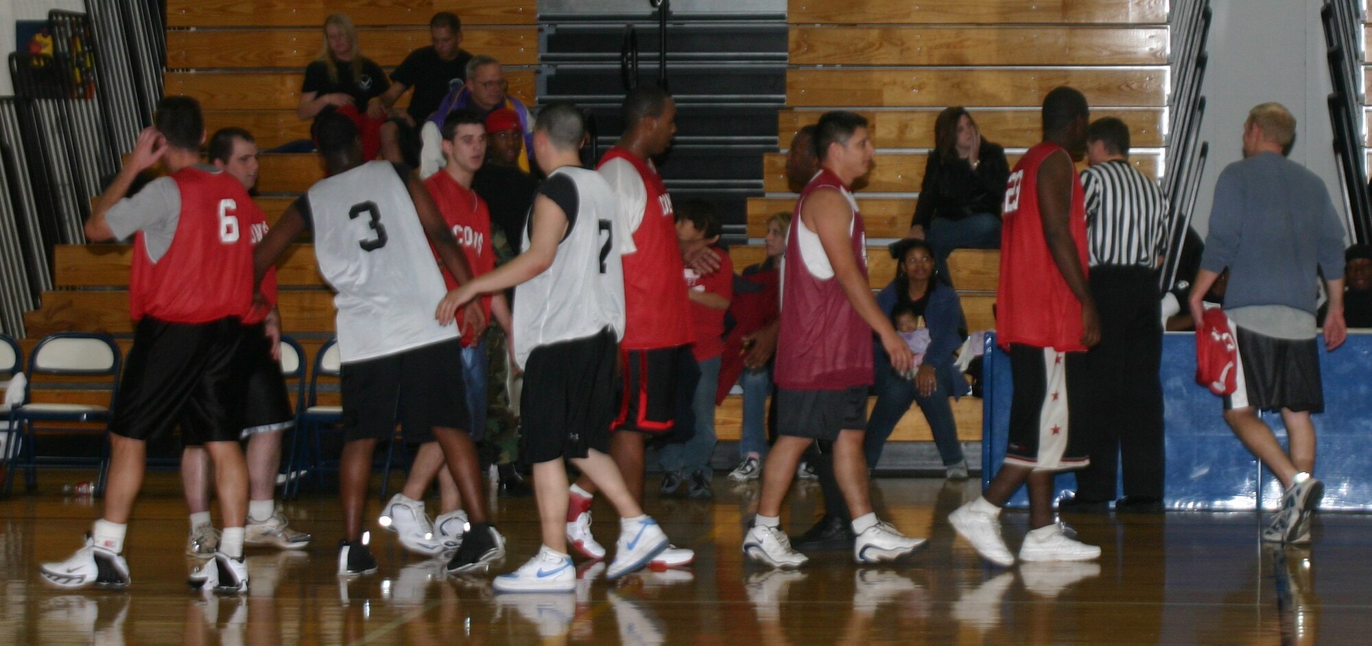 Members of the 82nd Contracting Squadron and 82nd Medical Operations Squadron intramural basketball teams congratulate each other after their game Jan. 8. The 82nd CONS won 67-30, taking their record to 5-0.